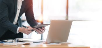 businessman-in-suit-is-working-on-digital-tablet-o-2024-12-06-11-44-18-utc350